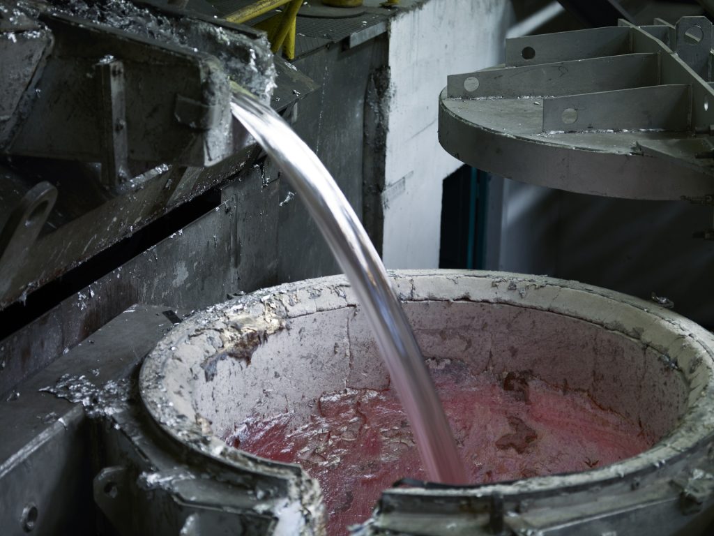 Pouring hot molten aluminum