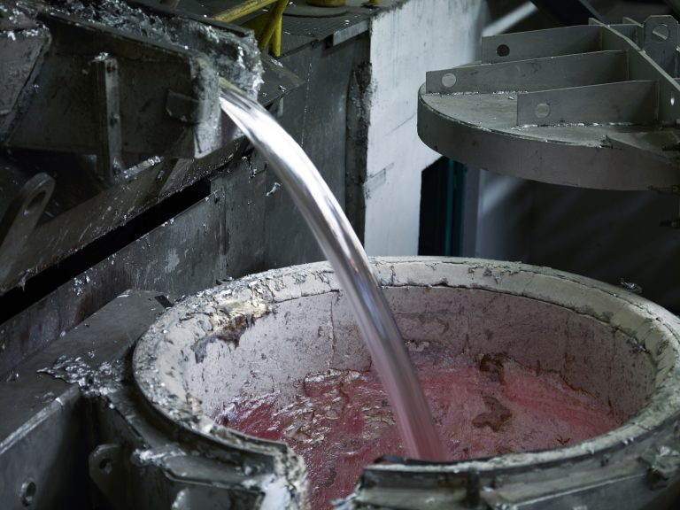 Pouring hot molten aluminum